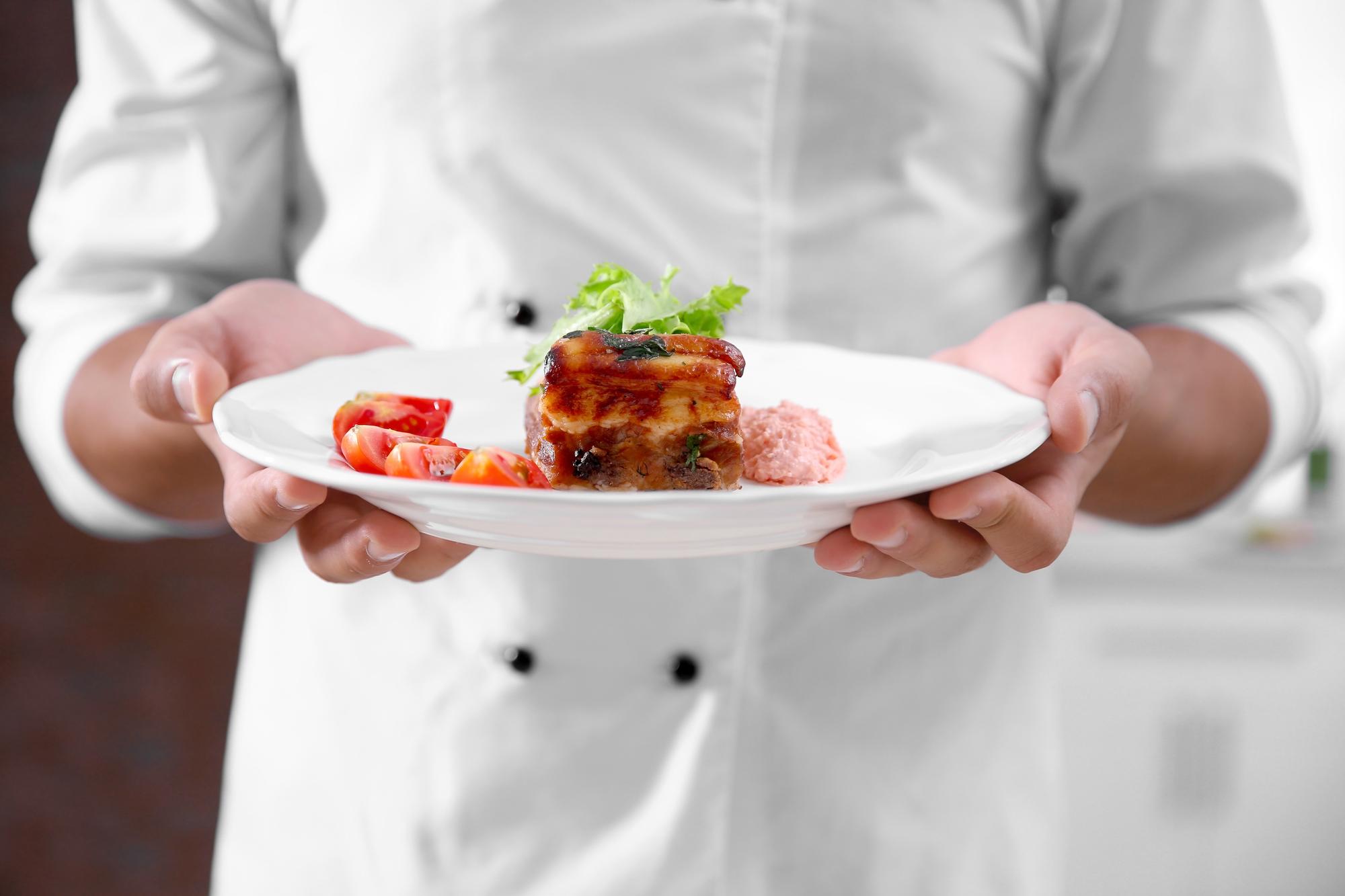 Chef preparing plate with seasonal ingredients